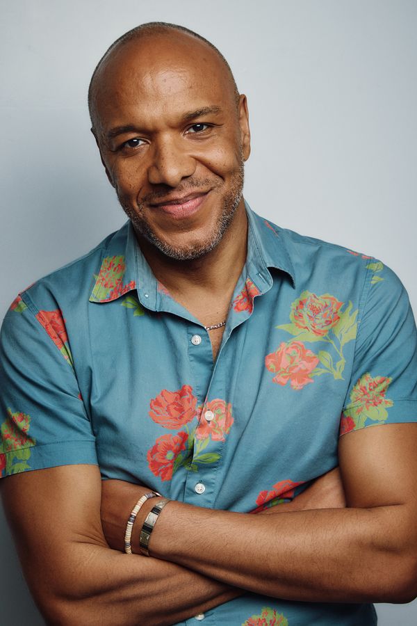 Alfred C. Kemp headshot, teal floral shirt, knowing smile