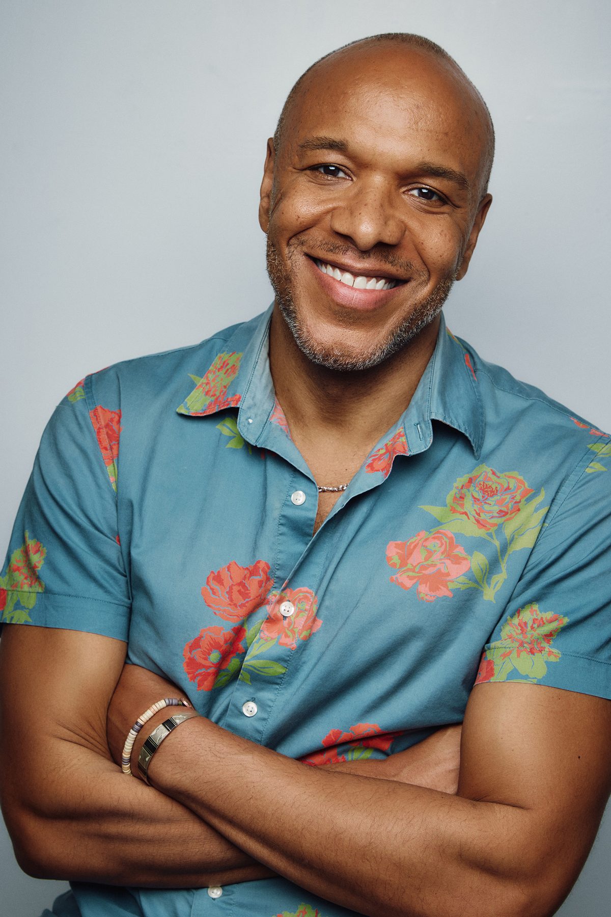 Alfred C. Kemp smiling in a teal floral shirt