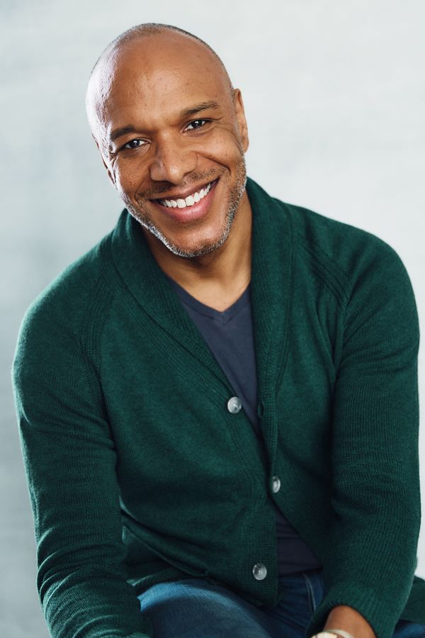 Alfred C. Kemp headshot, green cardigan, leaning in, smiling