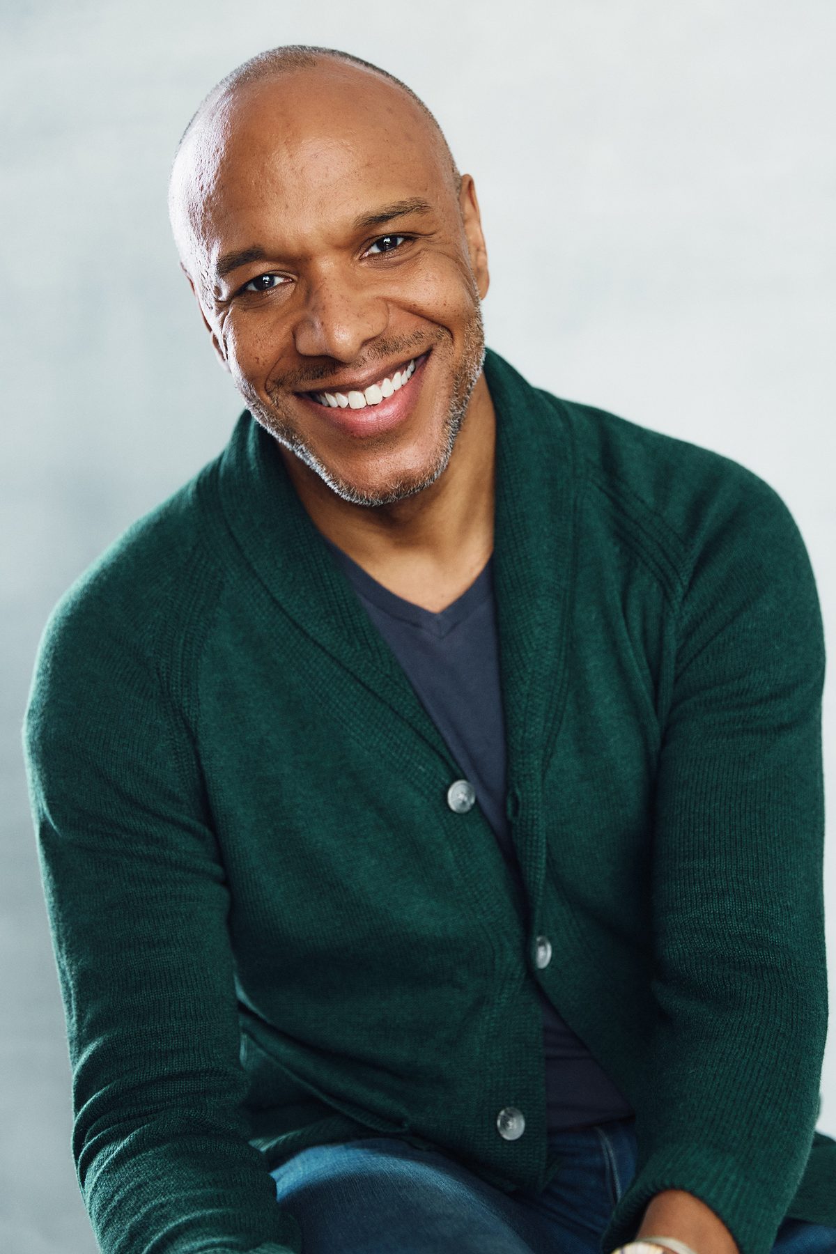 Alfred C. Kemp, actor, smiling in a green cardigan