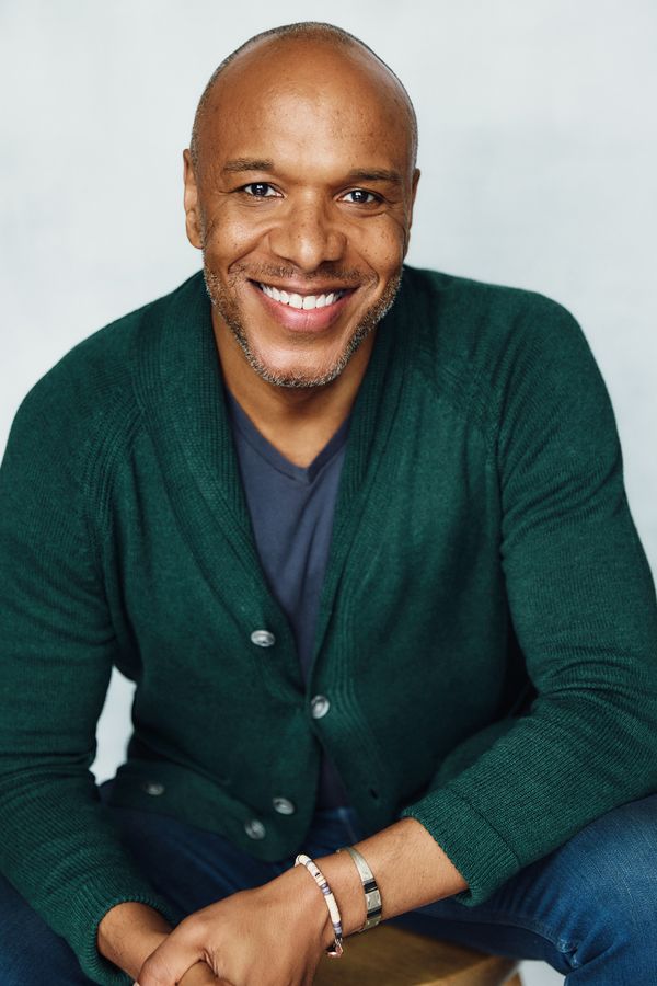 Alfred C. Kemp headshot, green cardigan, seated, smiling